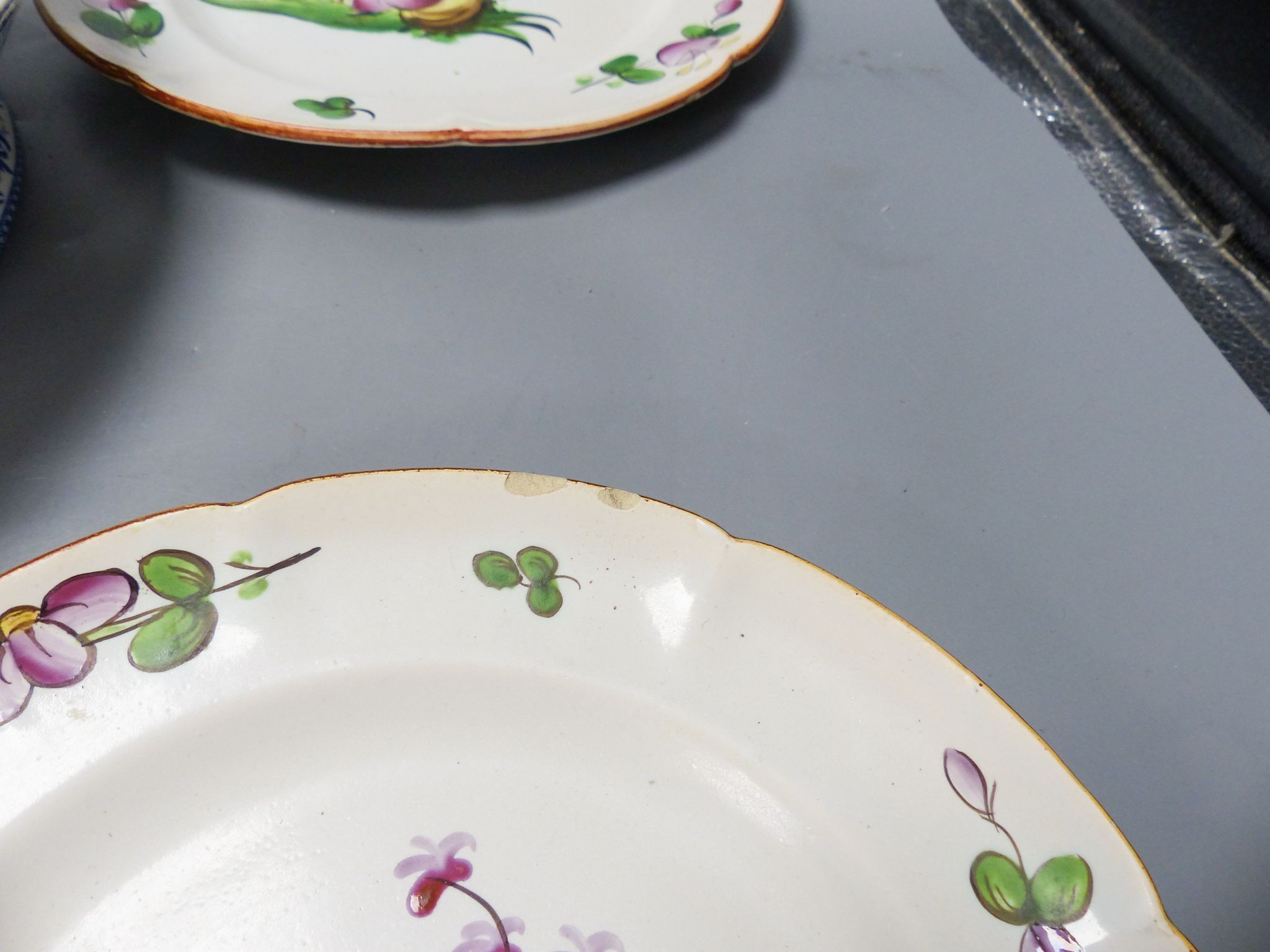 An ironstone cheese stand and a pair of French faience plates 30cm